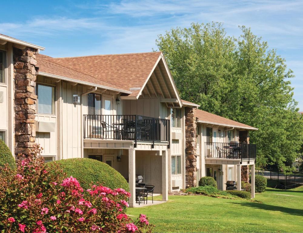 a large apartment building with balconies and flowers at WorldMark Grand Lake in Monkey Island