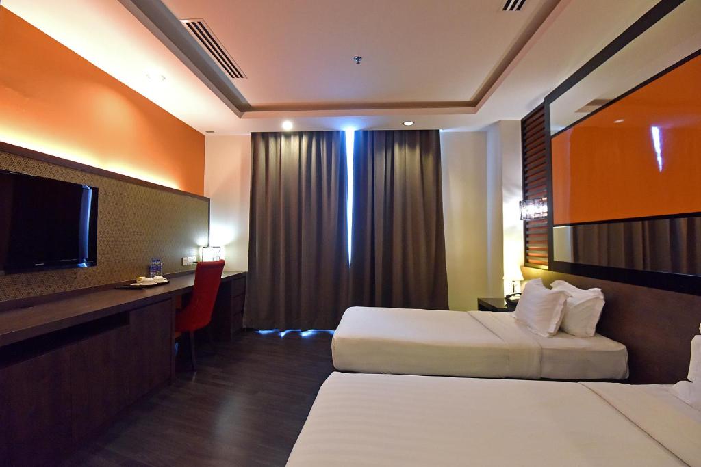 Postel nebo postele na pokoji v ubytování Jindagu Hotel Ipoh