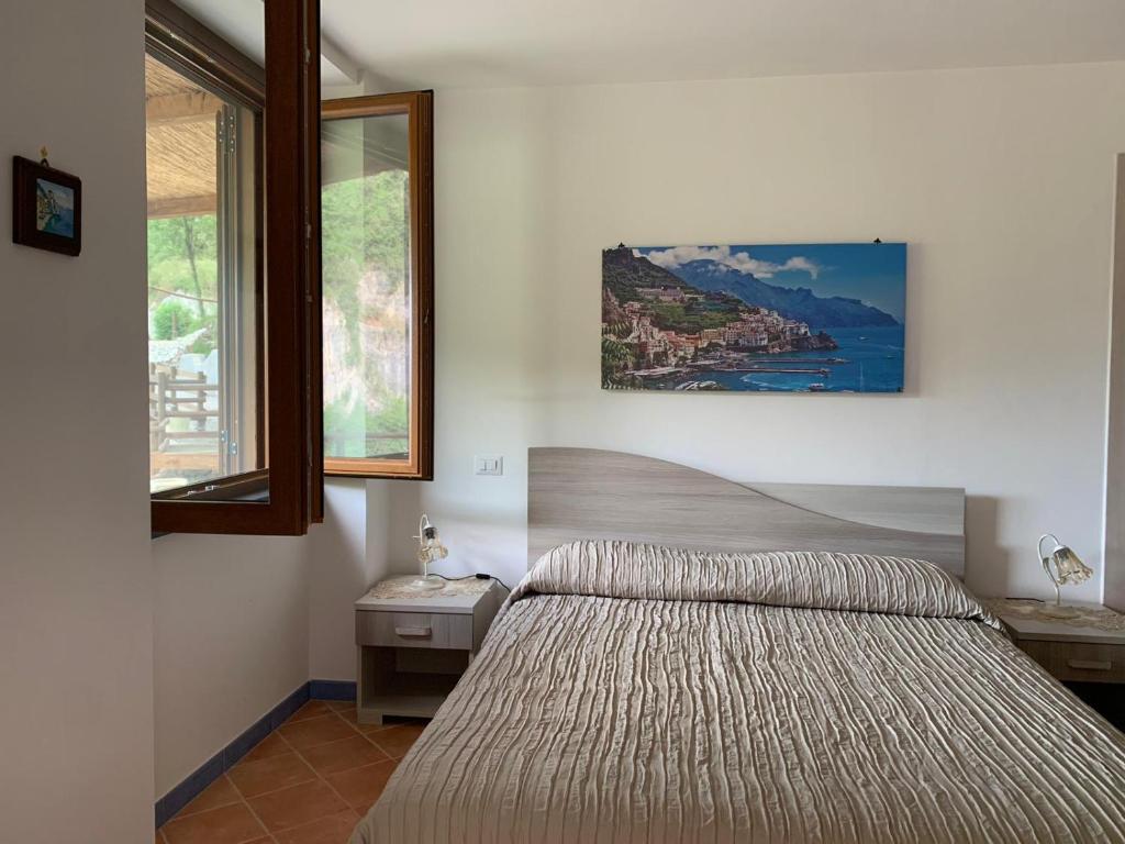 Un pat sau paturi într-o cameră la TENUTA BOSCO-Casa Vacanze