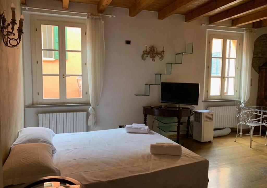 a bedroom with a bed and a tv and stairs at whouse suite GOLD TOWERS in Bologna