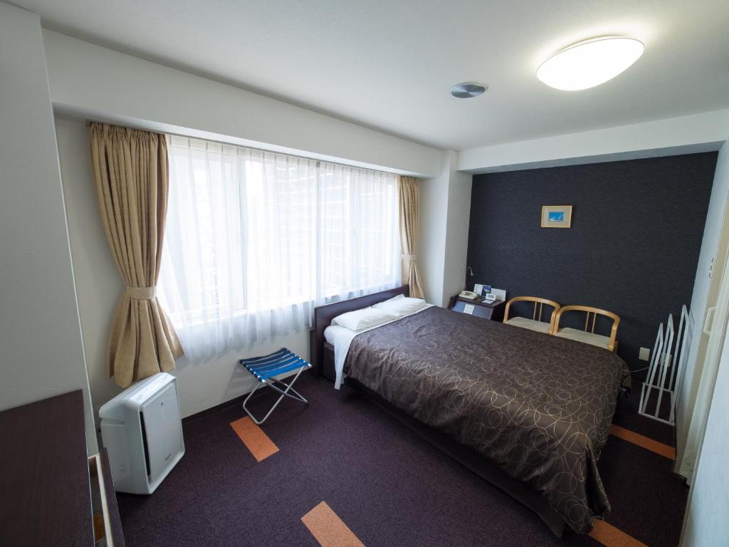Postel nebo postele na pokoji v ubytování Hotel Shin Osaka