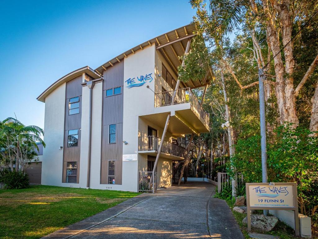 a building with a sign in front of it at The Waves Port Macquarie in Port Macquarie