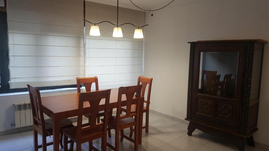 a dining room with a table and chairs and a mirror at Valls Rent in Andorra la Vella