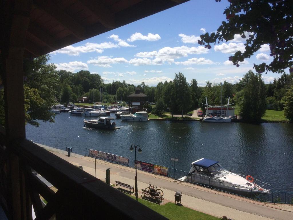 a view of a river with boats in it at Ekomarina - Pokój noclegowy 1 in Węgorzewo