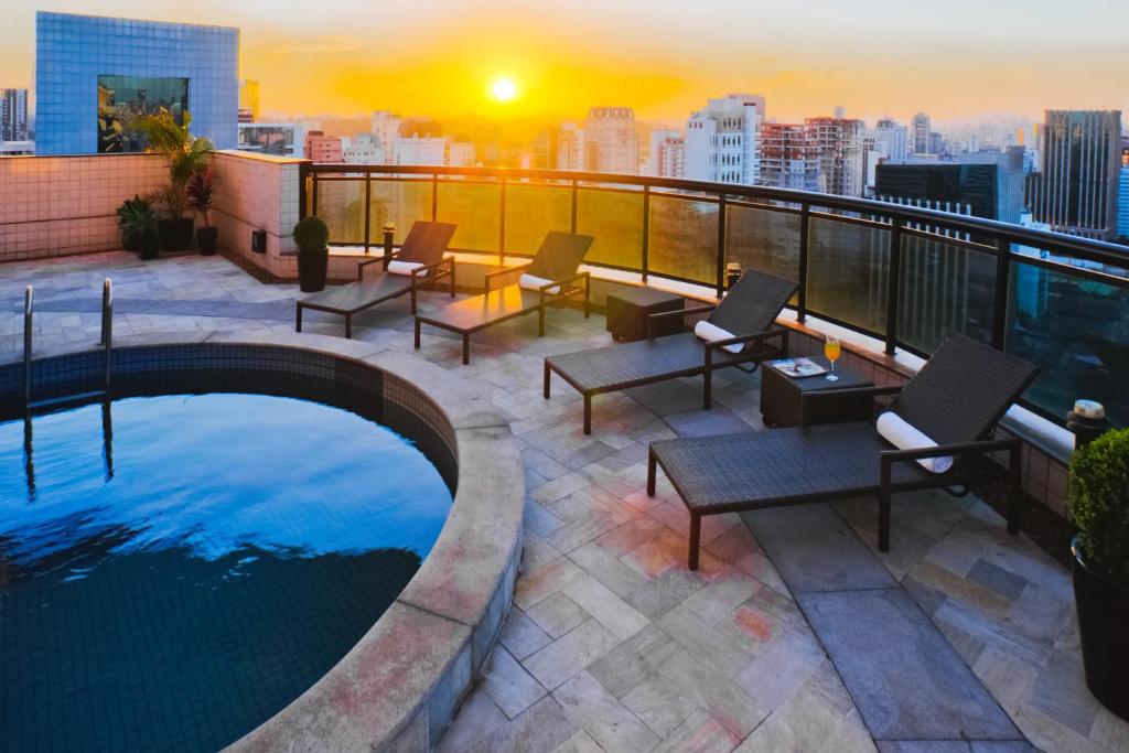 a rooftop patio with a swimming pool on a building at Blue Tree Premium Faria Lima in São Paulo