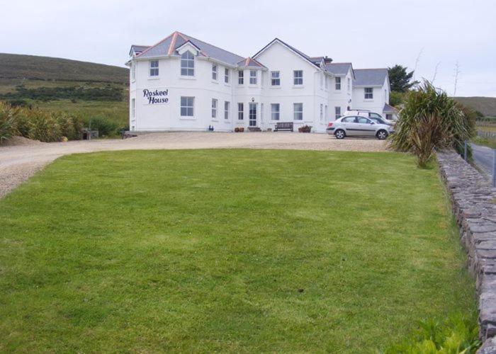a large white house with a car parked in front of it at Roskeel House in Achill
