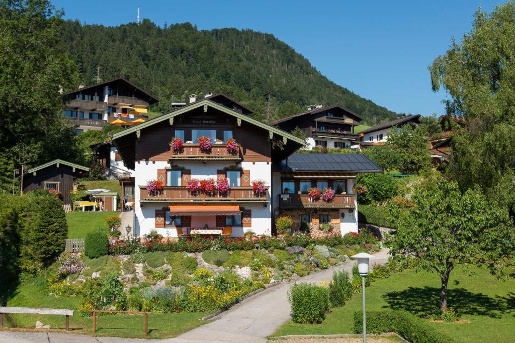 a house with flowers on the balconies of it at Haus Karoline in Reit im Winkl