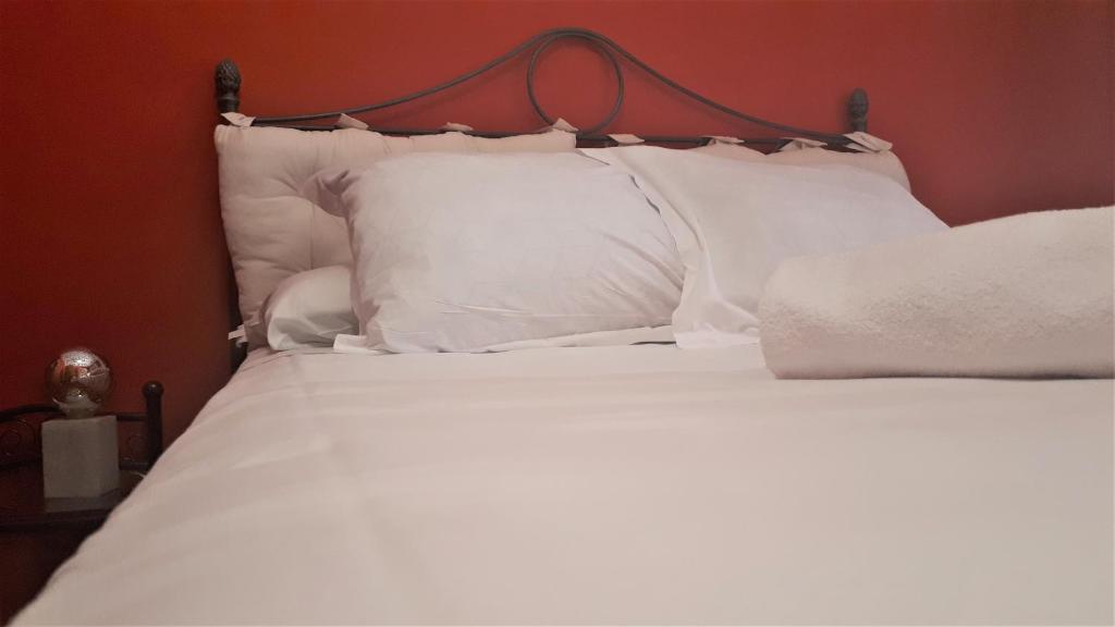 a white bed with white pillows in a bedroom at Nice 2 bedrooms Madrid downtown in Madrid