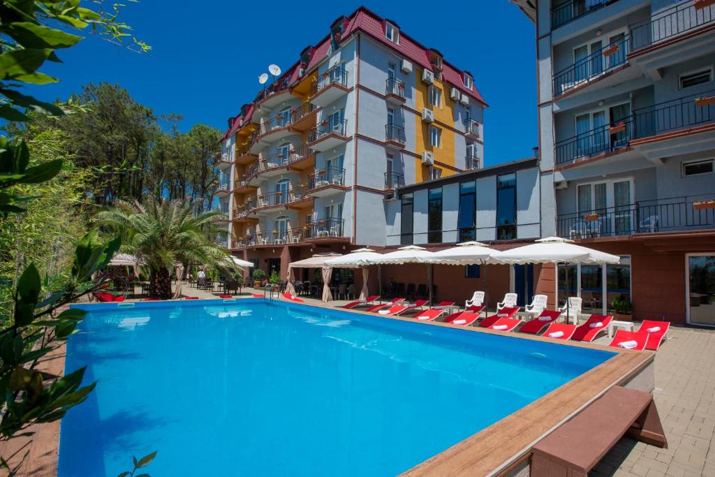 a large swimming pool in front of a hotel at Iveria Elli Hotel in Shekvetili
