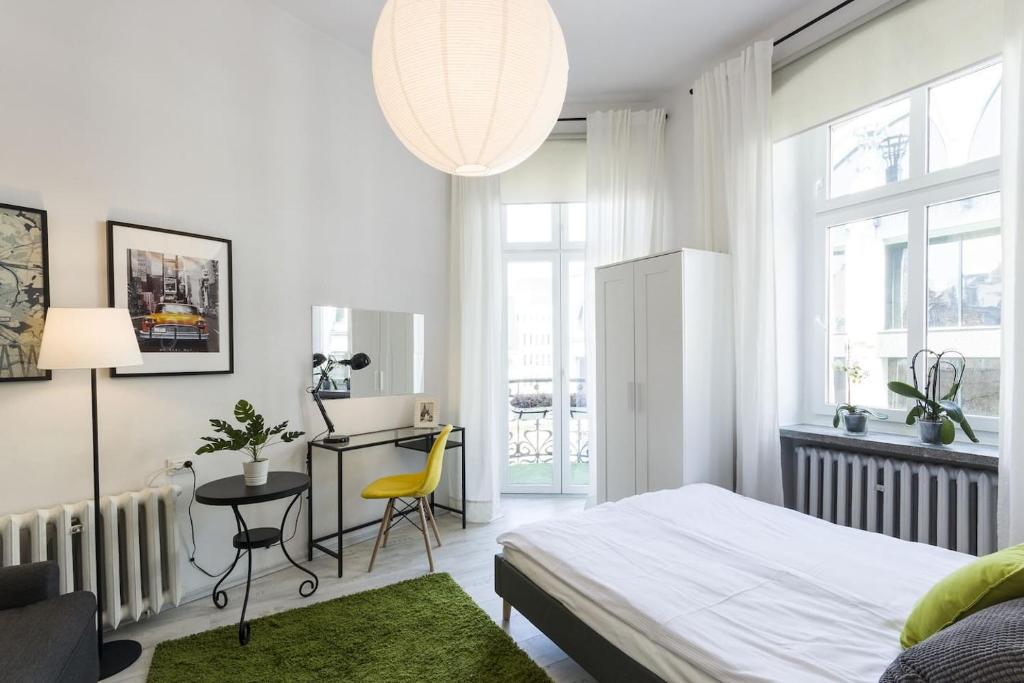 a bedroom with a bed and a desk and a chair at Ruska Street Old Town - BIG - Climatic Apart - 11 people - 300m Town Hall in Wrocław