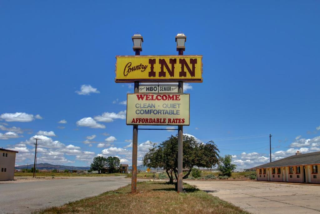 a sign for a motel on the side of a road at Country Inn Beaver Utah in Beaver