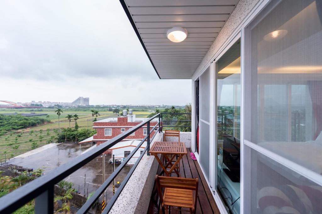 a balcony with a view of the countryside at Taitung Quality B&amp;B in Taitung City