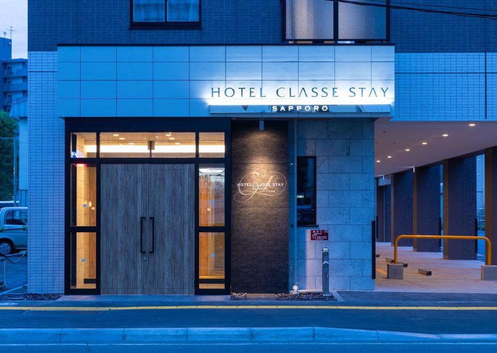 a hotel glass building with a sign on it at Hotel Classe Stay Sapporo in Sapporo