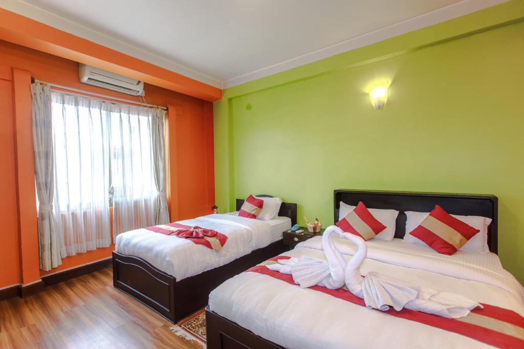 Postel nebo postele na pokoji v ubytování Hotel Nepalaya