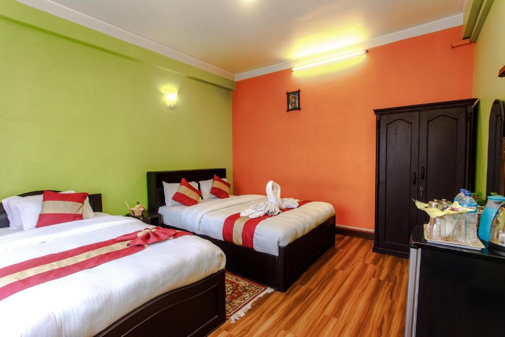 Postel nebo postele na pokoji v ubytování Hotel Nepalaya