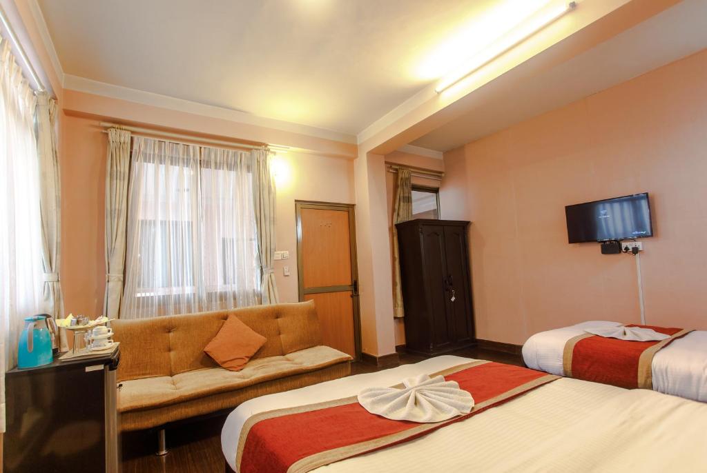 Postel nebo postele na pokoji v ubytování Hotel Nepalaya