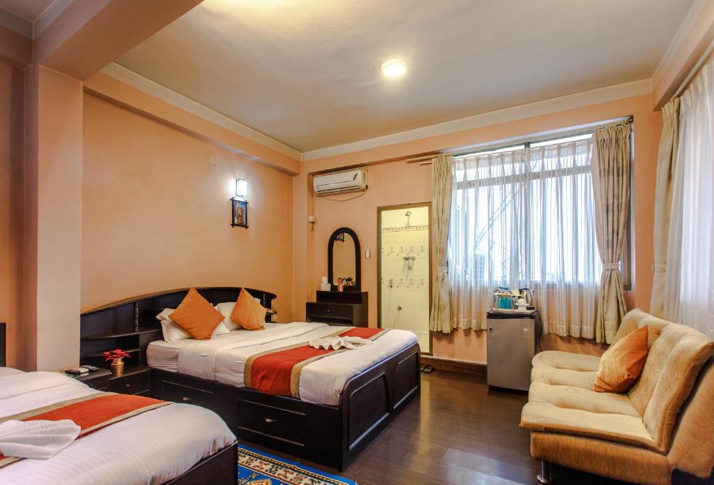 Postel nebo postele na pokoji v ubytování Hotel Nepalaya