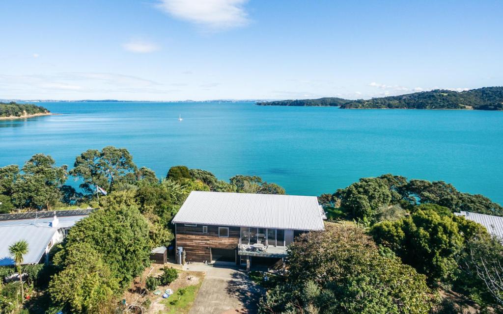 an aerial view of a house next to the water at Tui Point in Surfdale