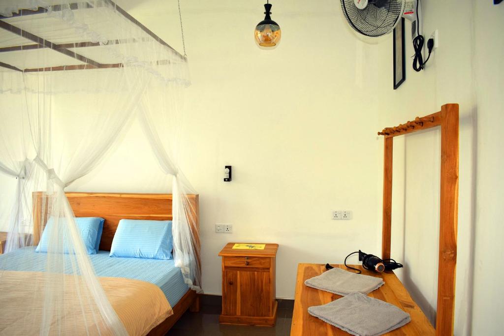 Postel nebo postele na pokoji v ubytování Raveena Guest House