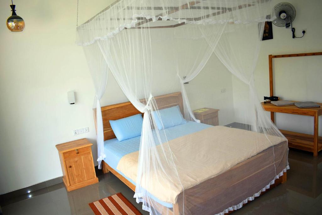 Postel nebo postele na pokoji v ubytování Raveena Guest House