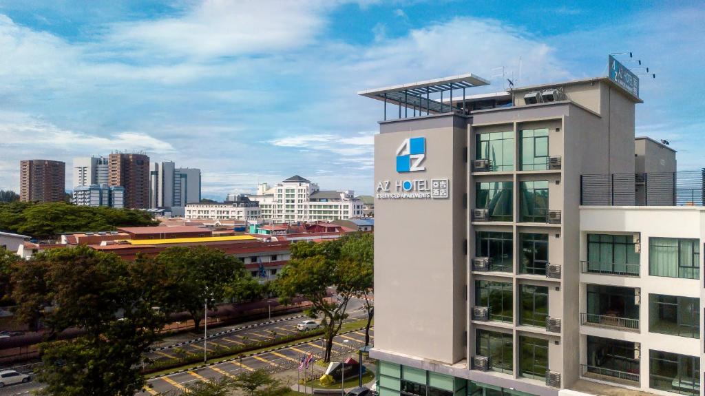 a building with a sign on top of it in a city at AZ Hotel & Serviced Apartments in Labuan