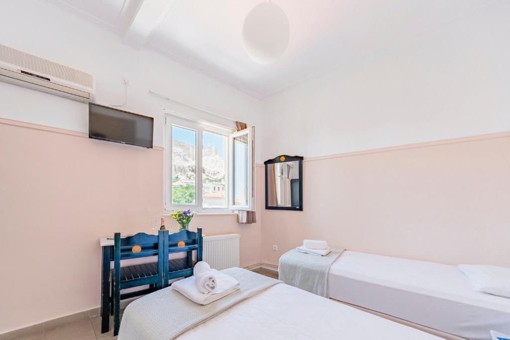 Postel nebo postele na pokoji v ubytování Phaedra Hotel
