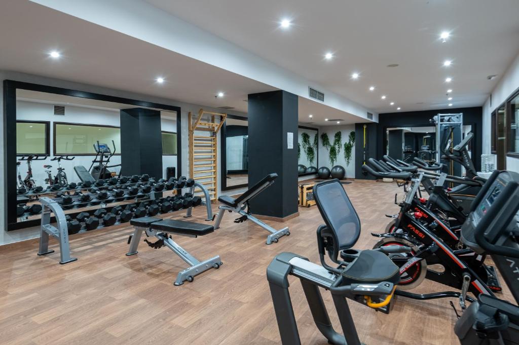 a gym with treadmills and elliptical machines at Michelangelo Resort & Spa in Ágios Fokás