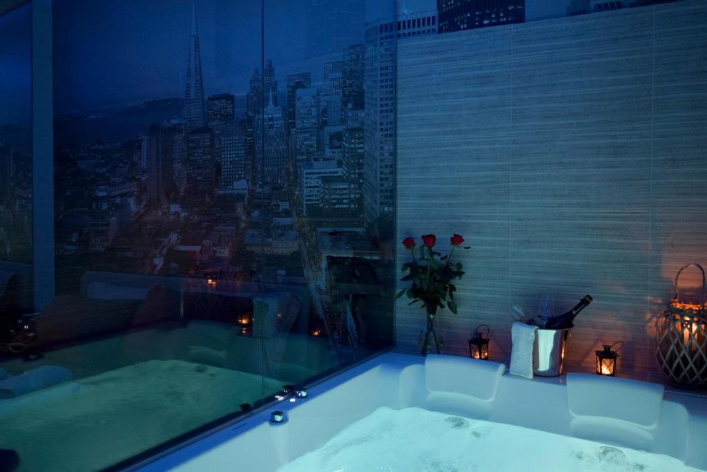 a bath tub with a view of a city at Nephele Luxury Suite in Thessaloniki