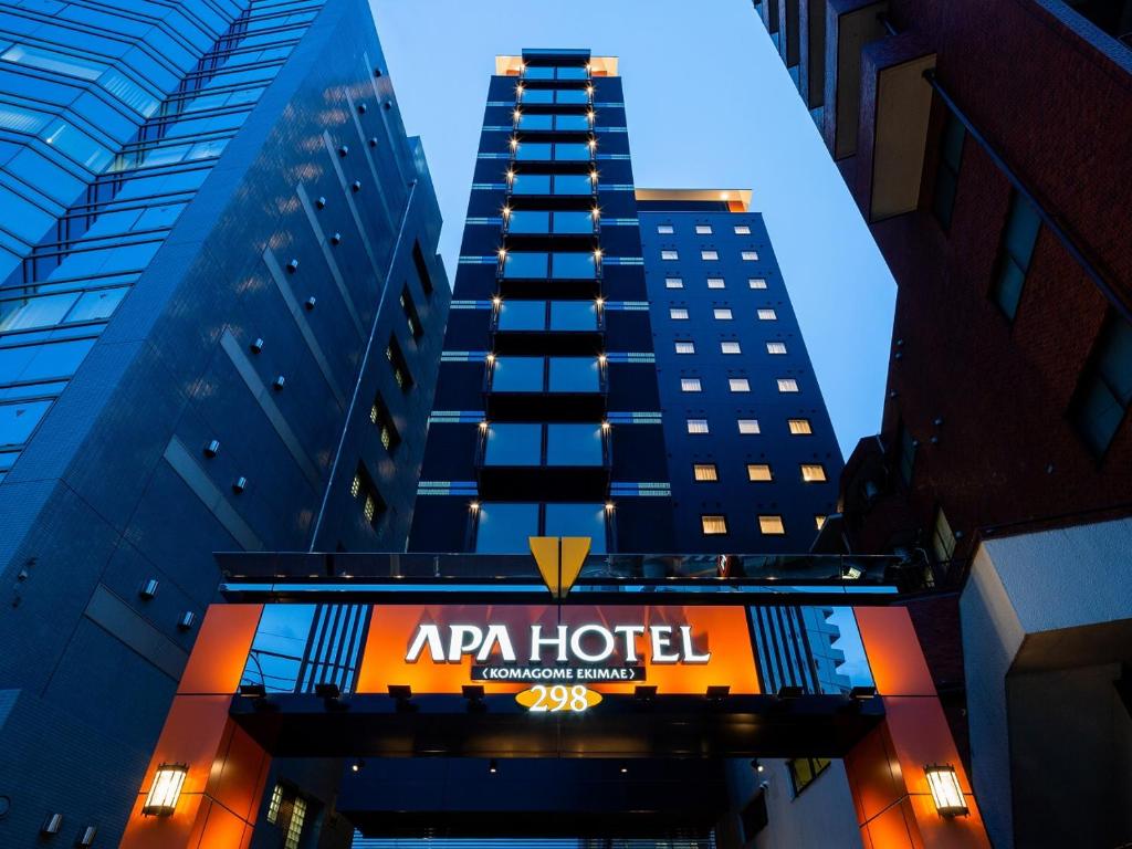 a tall building with an apa hotel sign on it at APA Hotel Komagome Ekimae in Tokyo