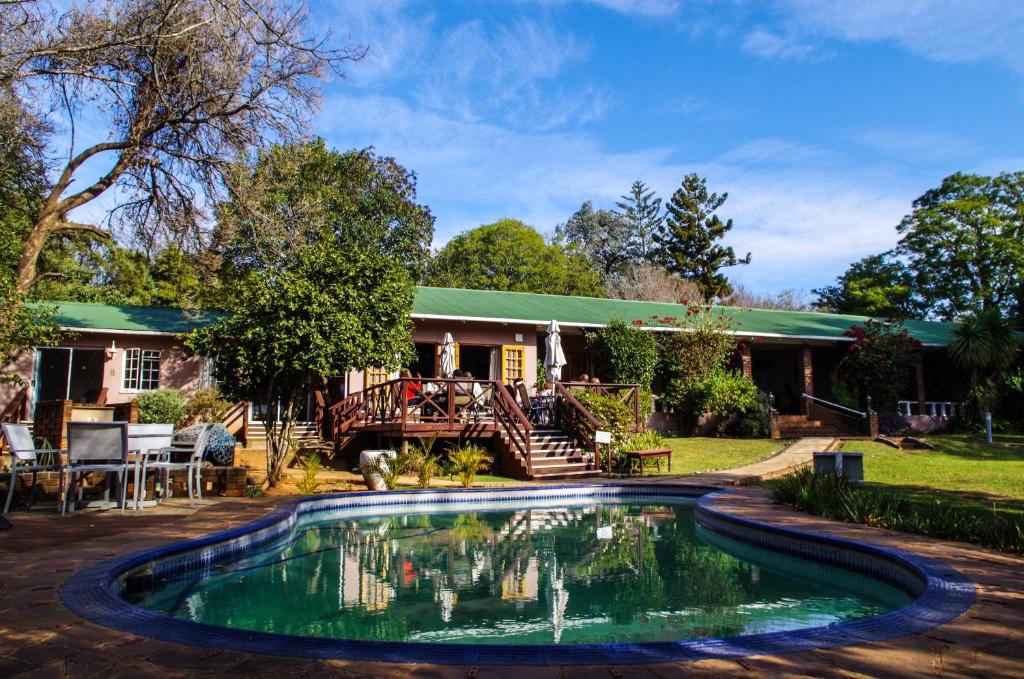 a house with a swimming pool in the yard at The Manderson Hotel and Conference Centre in Stutterheim