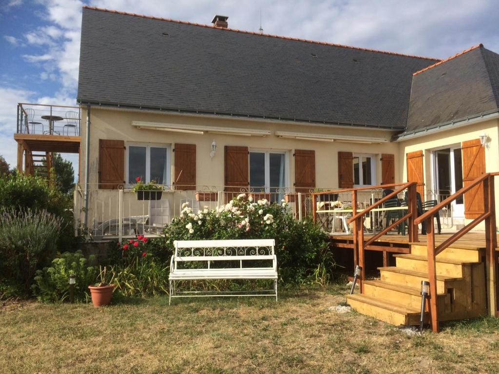 a house with a bench in front of it at Les petits chenes in La Pellerine