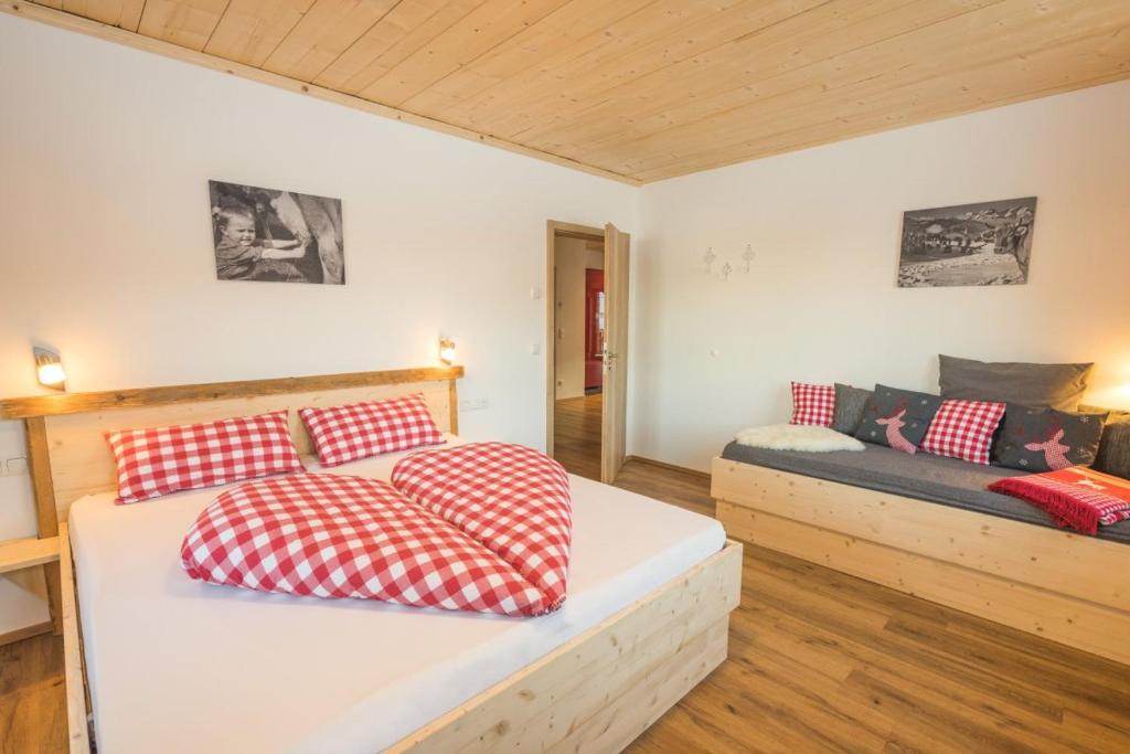 a room with a bed and a couch at Landhaus Panorama in Bad Hindelang