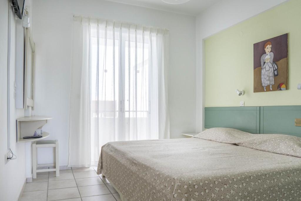 Postel nebo postele na pokoji v ubytování Pinelopi Hotel