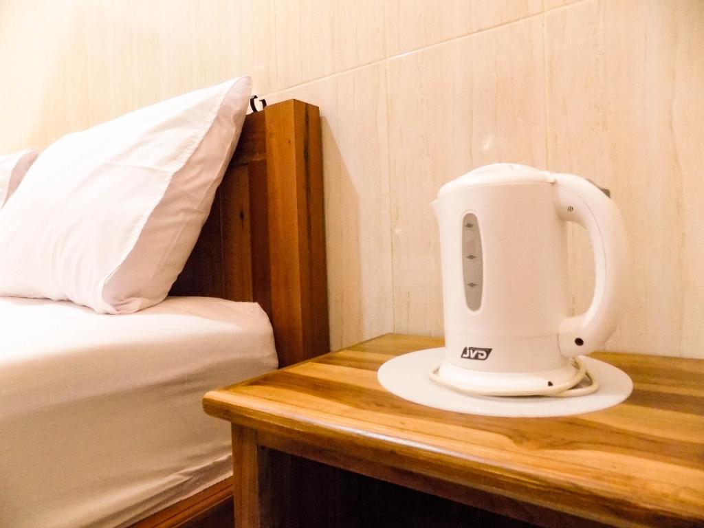 Postel nebo postele na pokoji v ubytování Guna Graha Kuta by Kamara