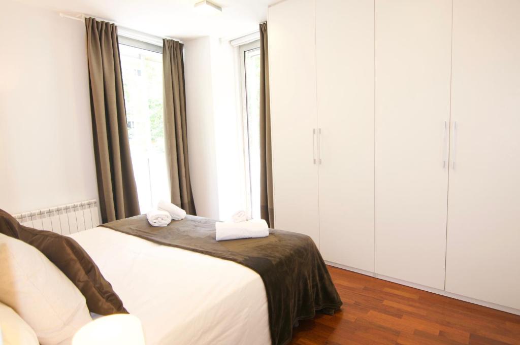 Postel nebo postele na pokoji v ubytování Glasir Apartments Barcelona