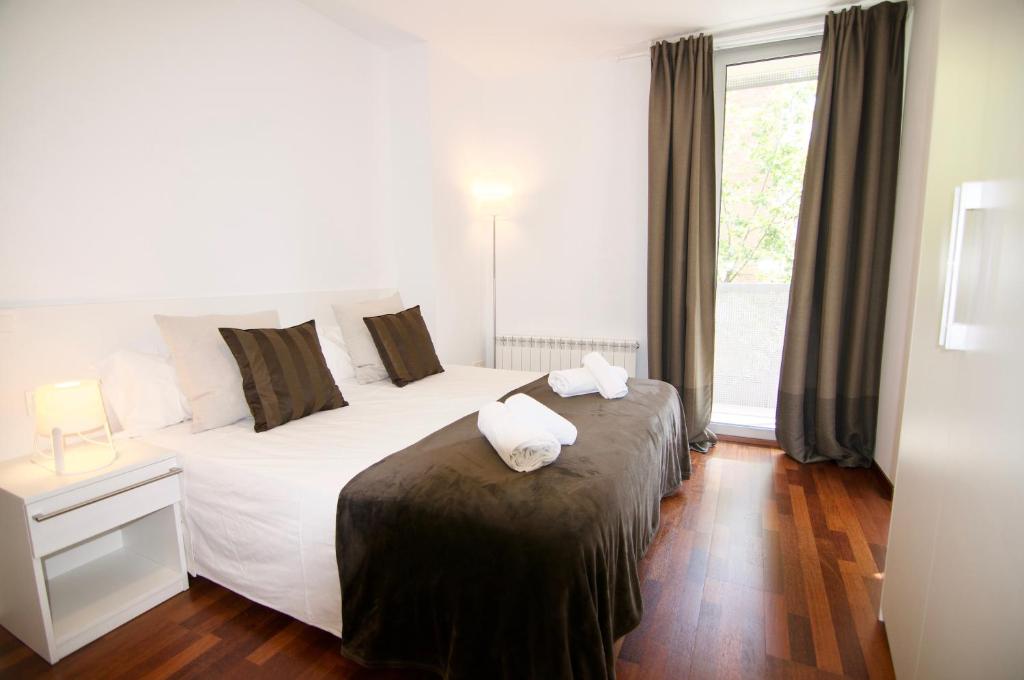 Postel nebo postele na pokoji v ubytování Glasir Apartments Barcelona