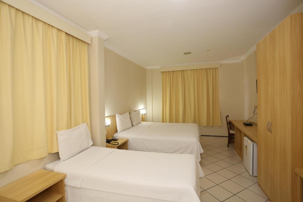 En eller flere senge i et værelse på Litorânea Praia Hotel