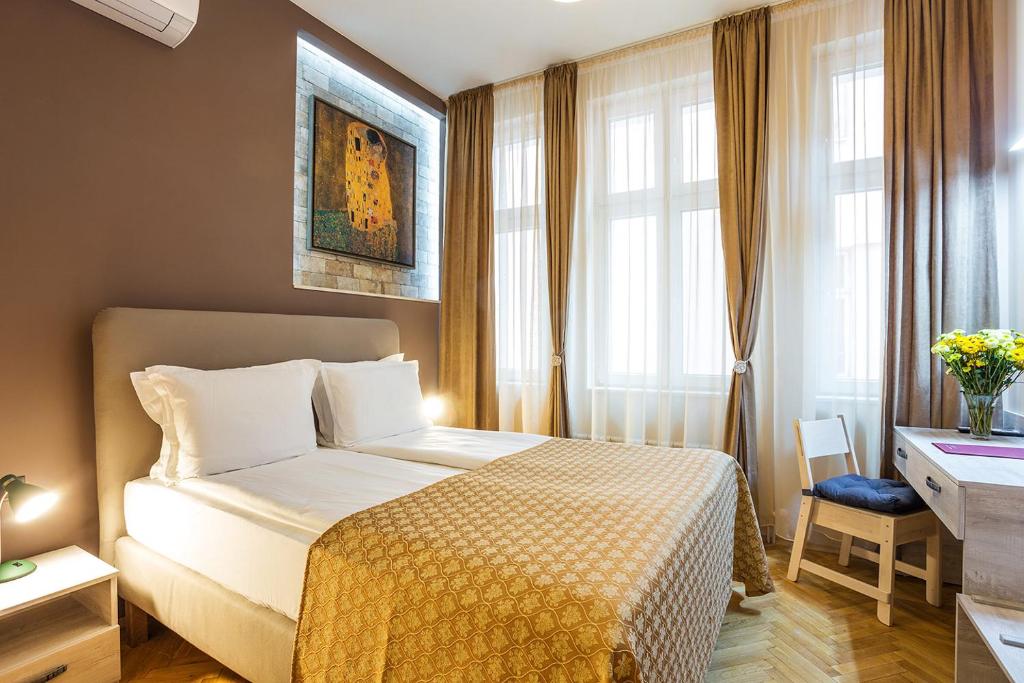 a hotel room with a bed and a desk and window at Sofia Place Hotel by HMG in Sofia