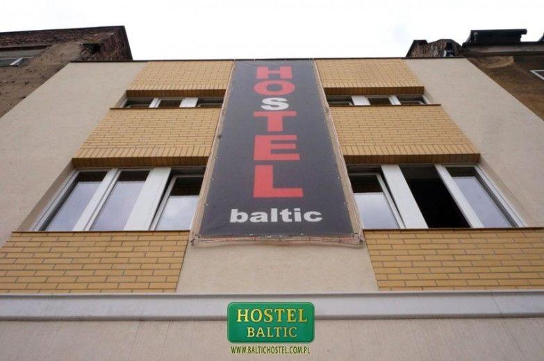 a hotel sign on the side of a building at Baltic Hostel in Gdańsk
