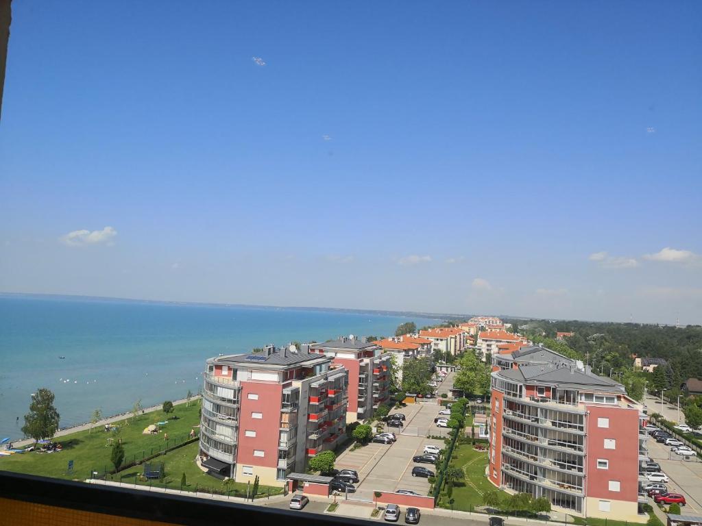 an aerial view of a city with buildings and the water at Panoráma906 Apartman in Siófok