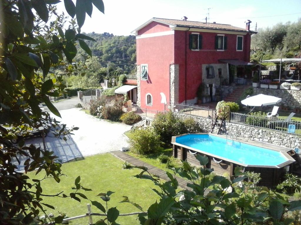 a villa with a swimming pool in front of a house at Luci sul Golfo in La Spezia