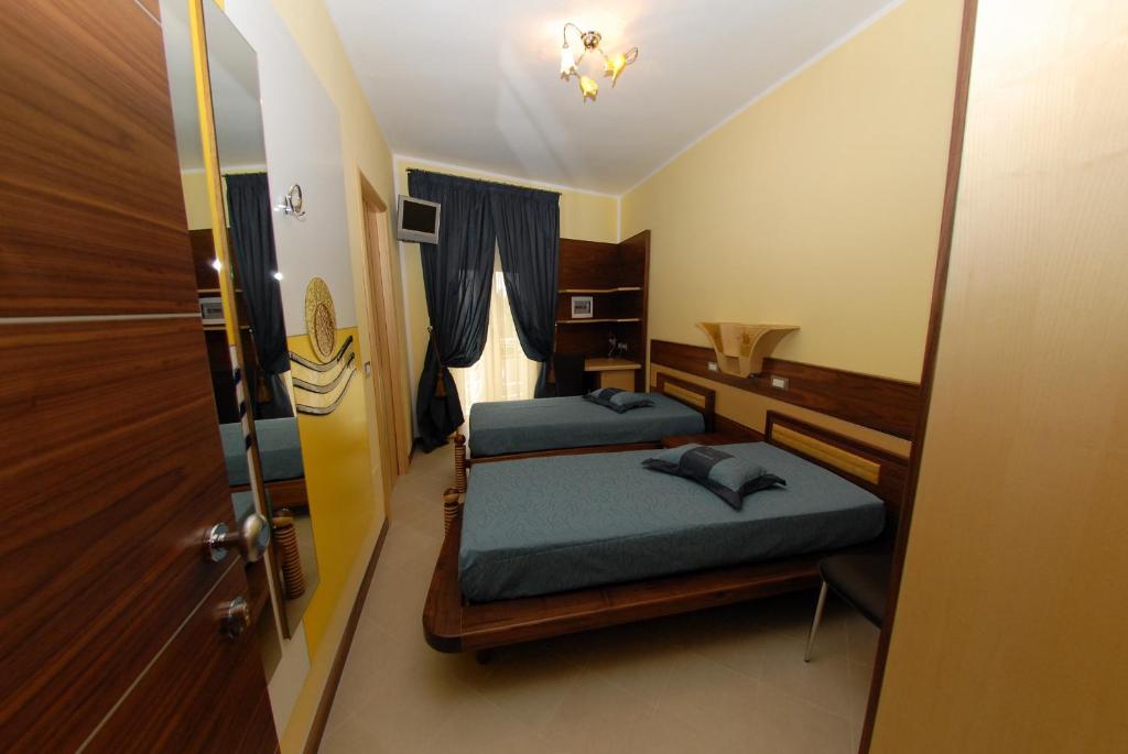 Postel nebo postele na pokoji v ubytování Hotel Miramare
