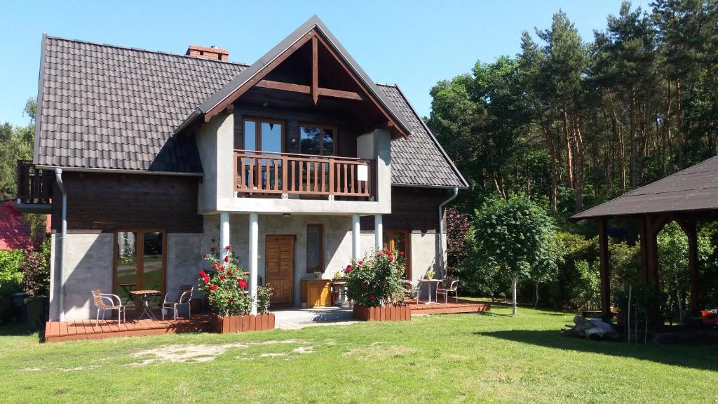 a large house with a porch and a balcony at Tajemniczy Ogród in Sztutowo