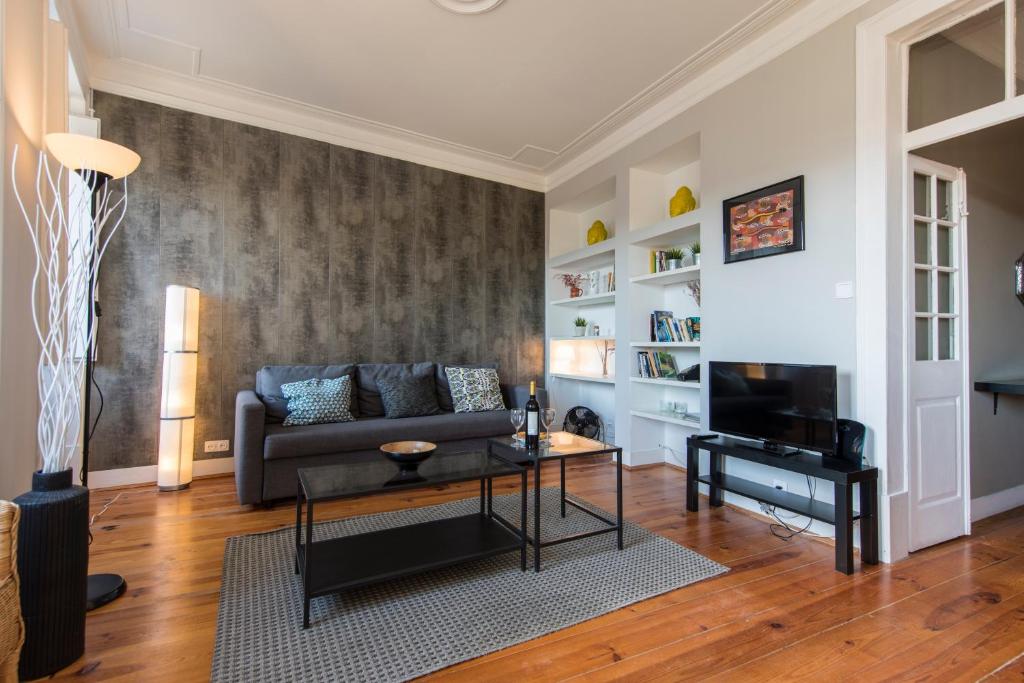 a living room with a couch and a table at Trendy & Lightfull Apartment in Lisbon