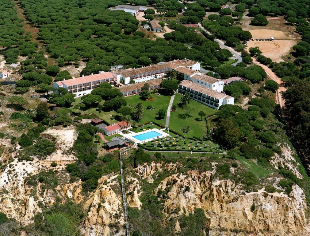 an aerial view of a house on a mountain at Parador de Mazagón in Mazagón