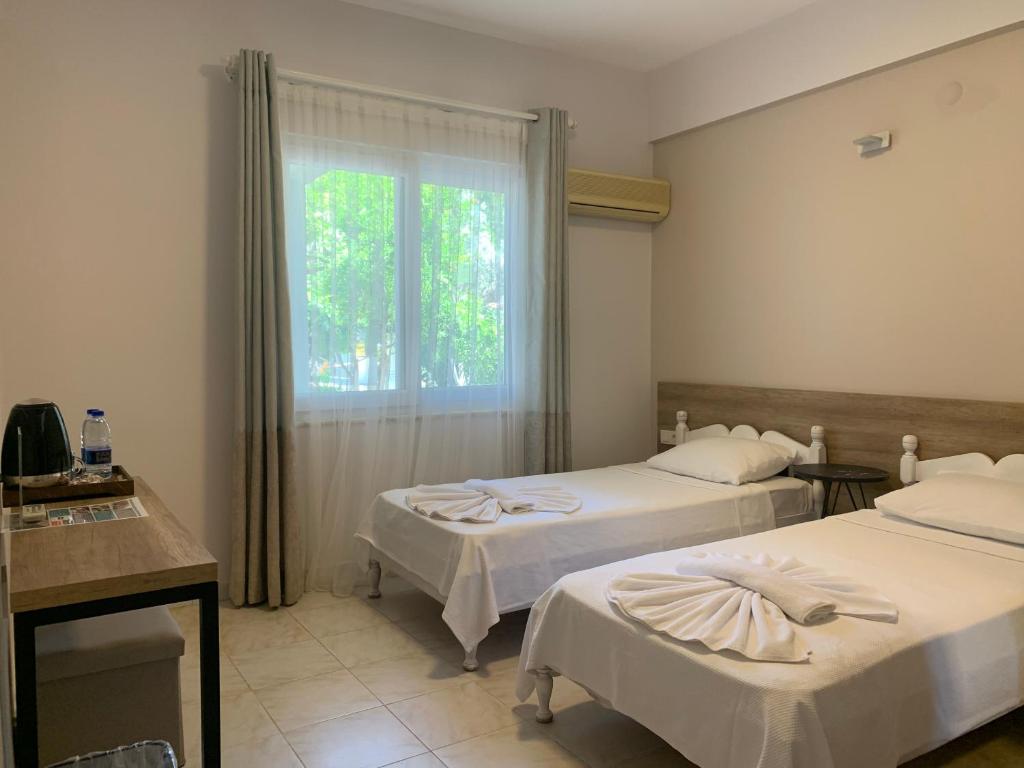 Postel nebo postele na pokoji v ubytování Kaizen Gate Hotel