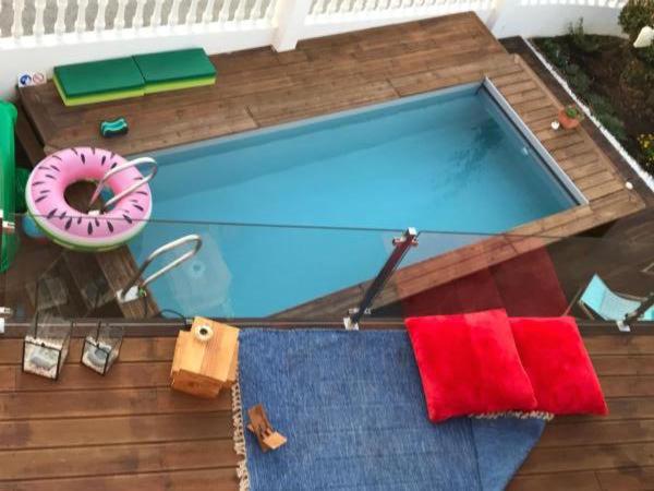 a swimming pool with a towel and a donut next to it at MappaMundo in Ribamar