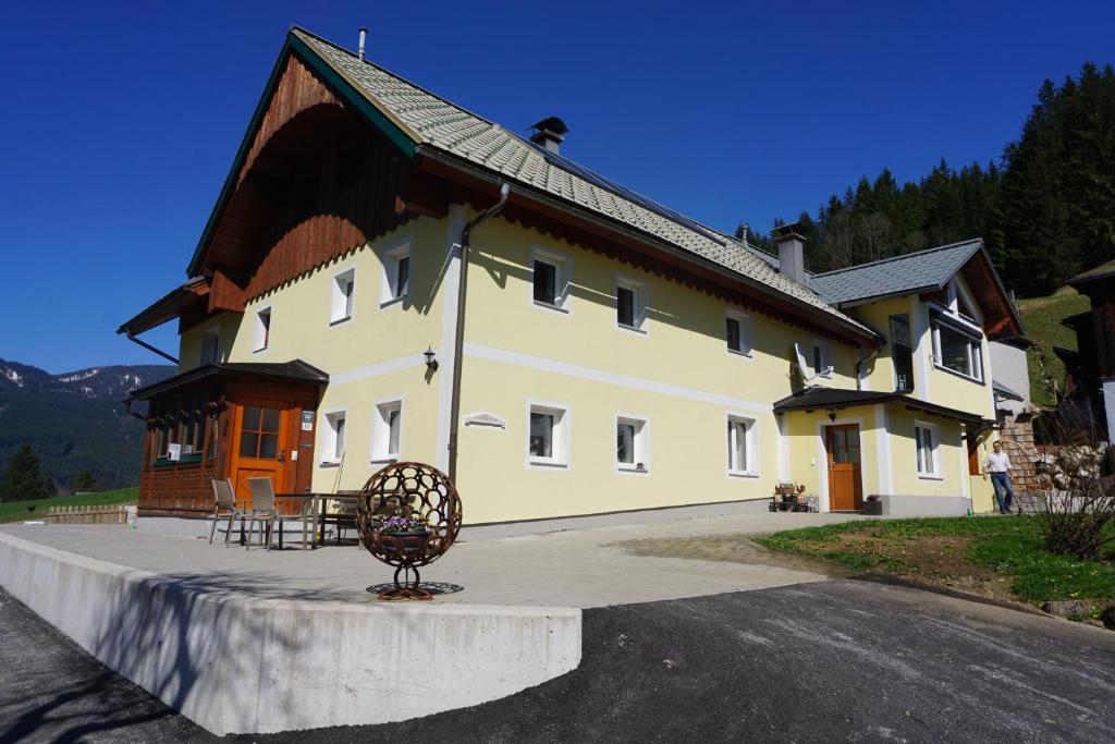 a large building with a sculpture in front of it at Schmiedsipplhof in Gosau