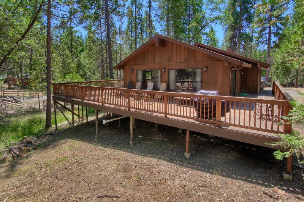 a large wooden cabin in the middle of a forest at 69 Bordentown West in Wawona