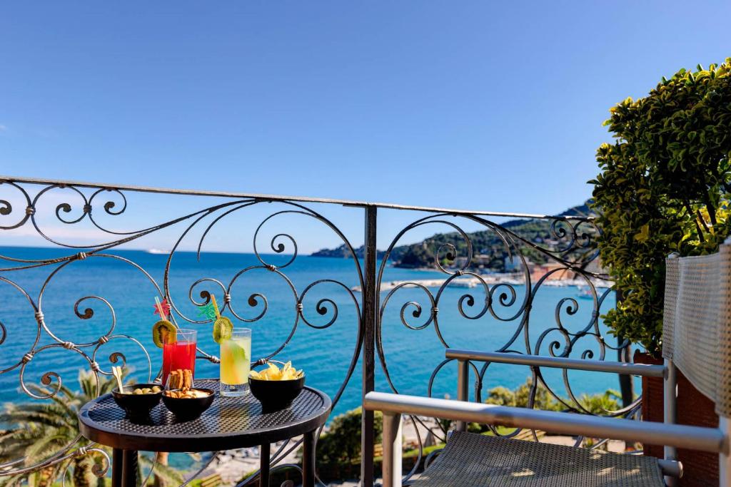 a table on a balcony with a view of the ocean at Hotel Continental in Santa Margherita Ligure